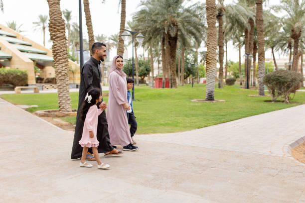 istock Middle Eastern couple walking with their children at the park 2195339529