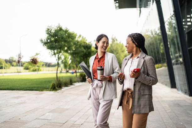 istock Two businesswomen talking while walking in the city 2195340007