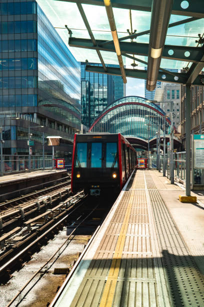 istock Driverless docklands light railway train arriving at station in london 2195343093