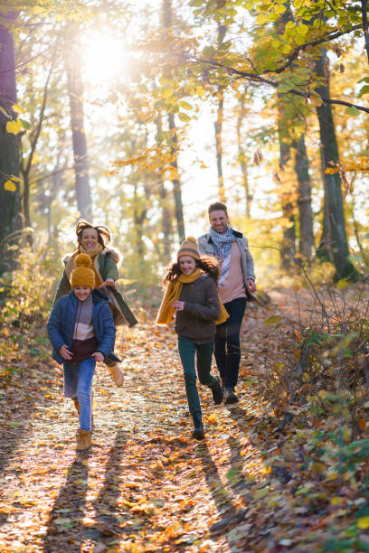 istock Children play with her parents in the forest 2195344339