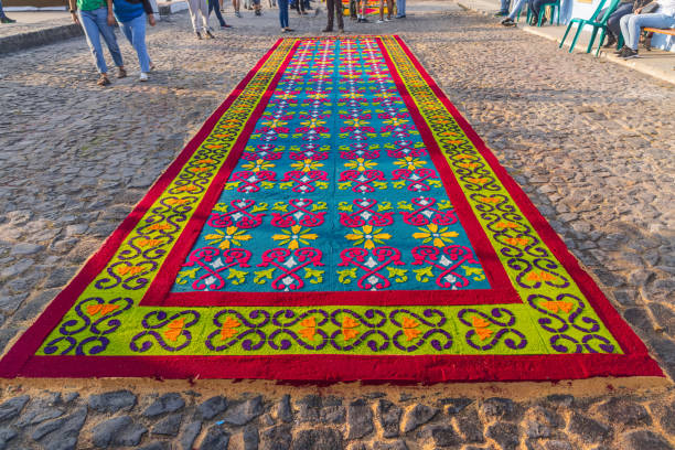 Antigua Guatemala, Sacatepequez, Guatemala. March 10, 2024. Creating alfombra decorations from brightly colored sawdust for Semana Santa Holy Week Easter celebrations.
