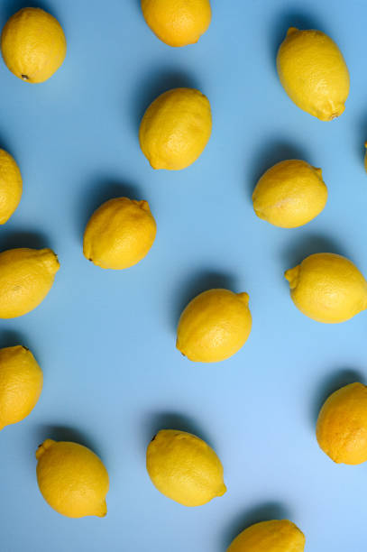 istock Top view of yellow lemons on blue background. 2195349767