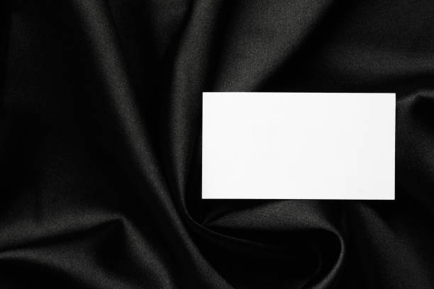 istock Blank business card on black fabric, top view. Mockup for design 2195349785