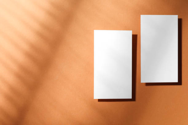 istock Empty business card on light brown background, top view. Space for text. Mockup for design 2195349873