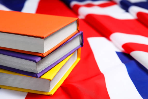 istock Learning foreign language. Different books on flag of United Kingdom, space for text 2195349969