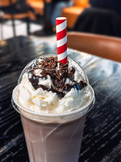 Chocolate Milkshake Closeup Detail Vertical Orientation - Indoors on table with blurred restaurant background.