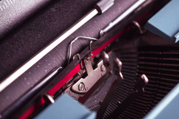 Red and black ink ribbon in an old typewriter machine close up