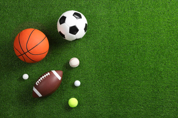 istock Many different sports balls on green grass, flat lay. Space for text 2195351760