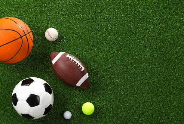 istock Many different sports balls on green grass, flat lay. Space for text 2195351835