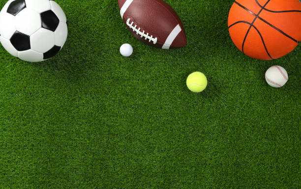 istock Many different sports balls on green grass, flat lay. Space for text 2195351894
