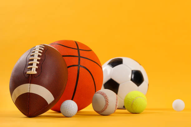 istock Many different sports balls on yellow background 2195352034