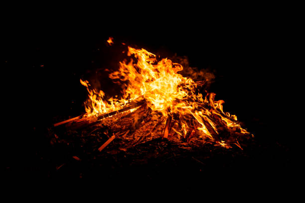 Close-up of a big bonfire on a dark night background. Space for copy.