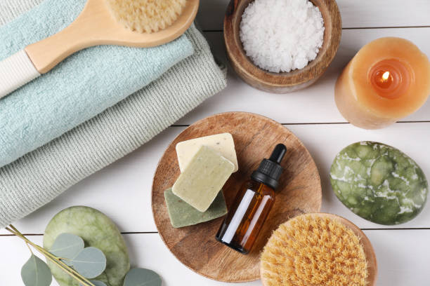 istock Flat lay composition with different spa products and burning candle on white wooden table 2195353948