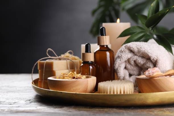 istock Spa composition. Dry flowers, bottles and soap bars on table, closeup 2195353962