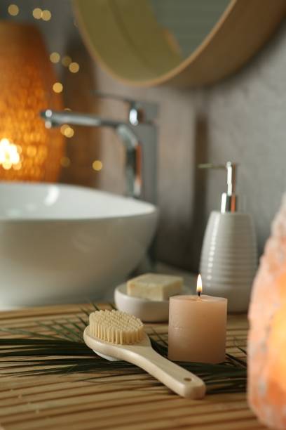istock Composition with different spa products and burning candle on countertop in bathroom 2195354021