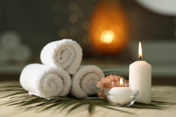 istock Composition with different spa products and burning candles on wooden table indoors 2195354030