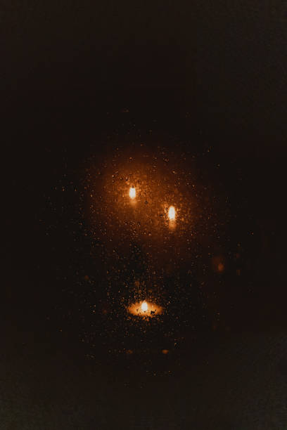 view of candles on wet window