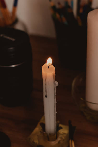 istock lit candle with black wax dripping 2195355071