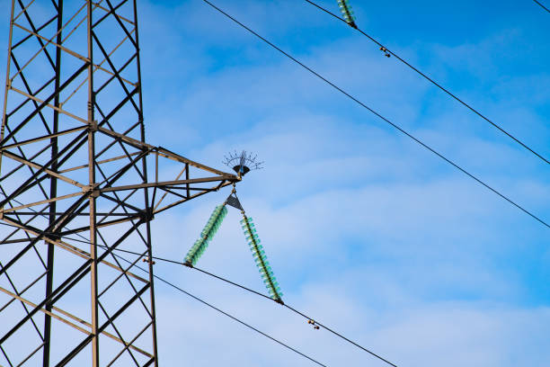 Electricity transmission with power lines against the sky. Closeup view with copy space (Voronezh region, Voronezh, Russia)