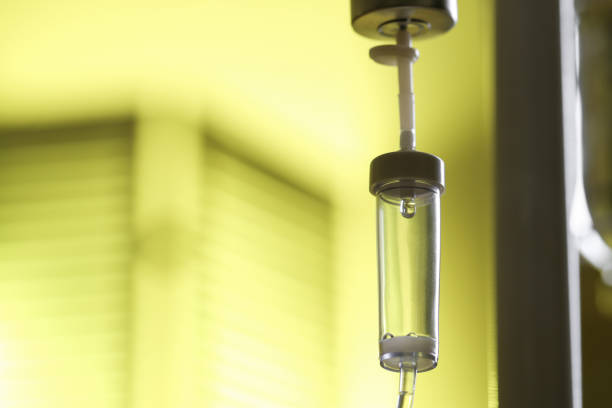 IV drip against blurred yellow background, space for text
