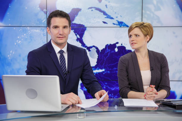 istock Journalists in a tv news studio 2195355466