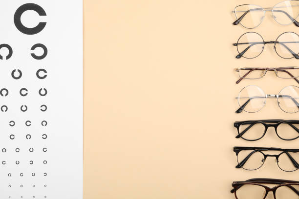 istock Vision test chart and glasses on beige background, flat lay. Space for text 2195355497
