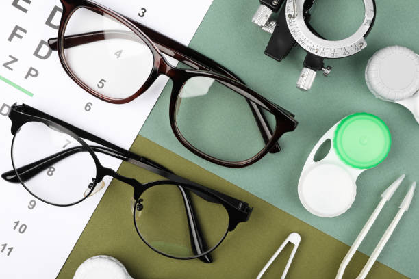 istock Flat lay composition with vision test chart and glasses on color background 2195355519