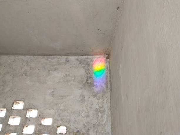 artificial rainbow created by mirror and water, reflection on corner of the wall