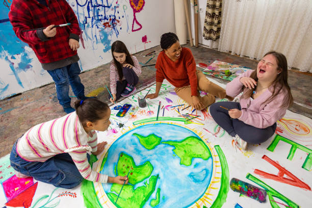 istock Teacher Encouraging Kids in Earth Day Art 2195362573