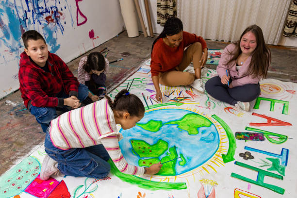 istock Teacher and Kids Create Earth Day Poster 2195362780