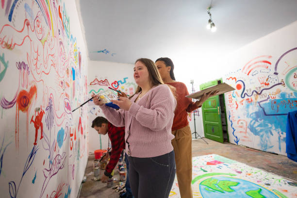istock Kids and Teacher Creating Wall Art 2195363065