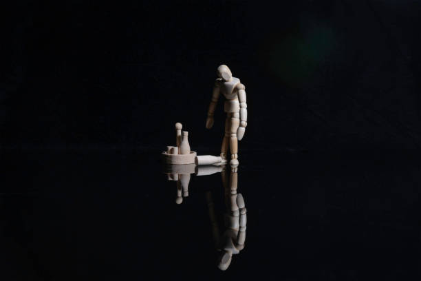 istock Standing Wooden Figure Contemplating Bottles 2195363616