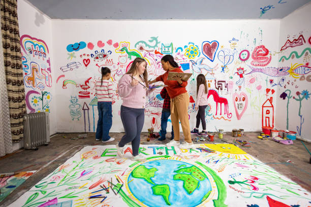 istock Girl with Down Syndrome Painting Mural 2195363686