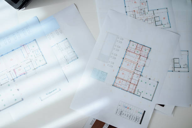 Architectural Floor Plans and Blueprint Documents on Bright Desk