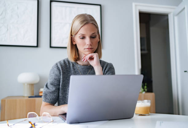 Young Professional Working on Laptop at Modern Home Workspace