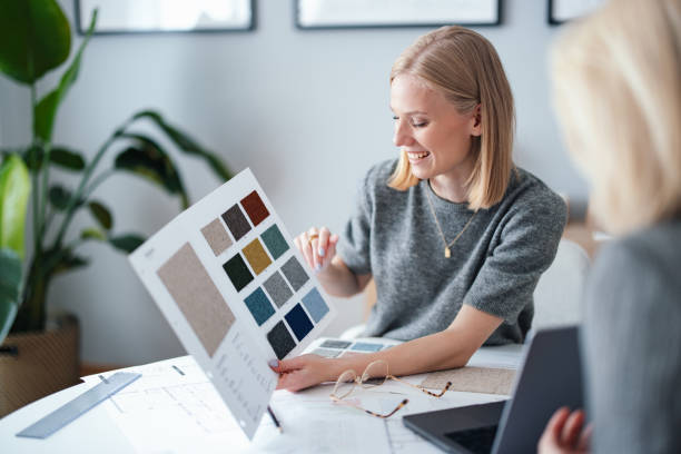 istock Young Businesswoman Discussing Fabric Sample Selection in Design Studio 2195365627