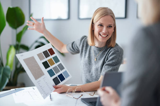 Young Professional Showing Color Samples in a Modern Design Studio