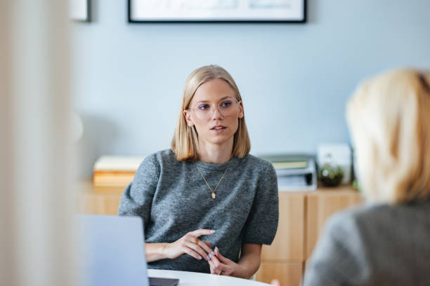 Focused Business Meeting Between Two Colleagues in Modern Office Setting