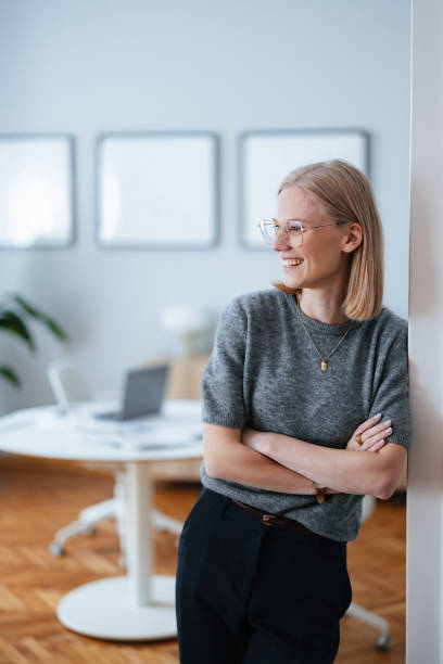 istock Smiling Young Woman in Bright Minimalist Office Setting 2195365644
