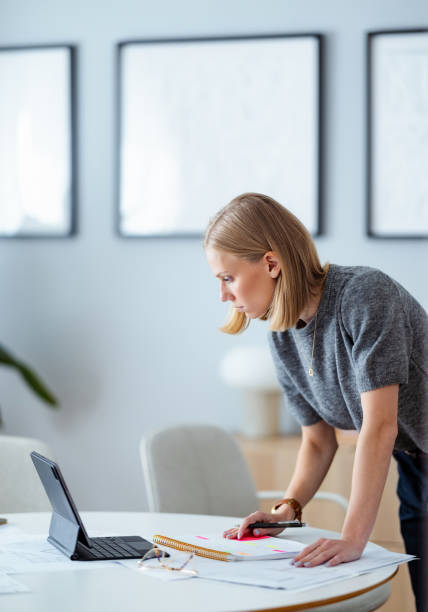 istock Focused Young Businesswoman Working in a Modern Home Office Environment 2195365647