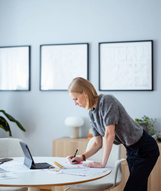 istock Young Businesswoman Working on Design Plans in Studio Office 2195365652