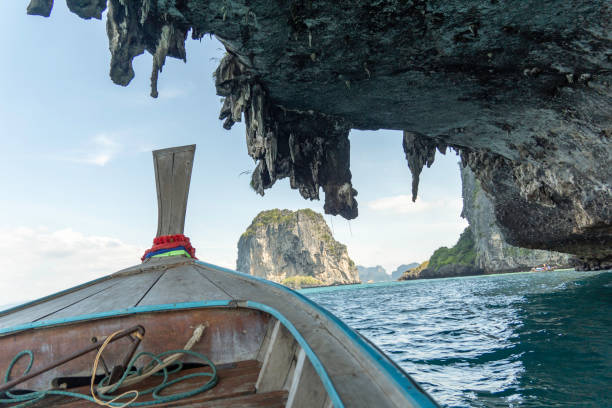 istock Scenic boat ride under towering limestone cliffs in Thailand's stunning coastal waters 2195365828
