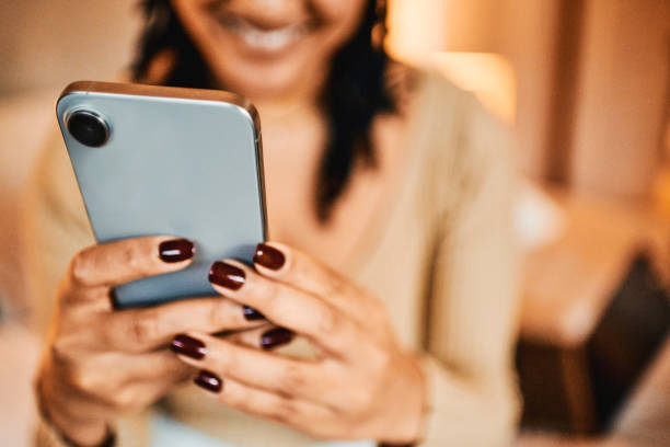 istock Close-up of woman text messaging using mobile phone 2195370532