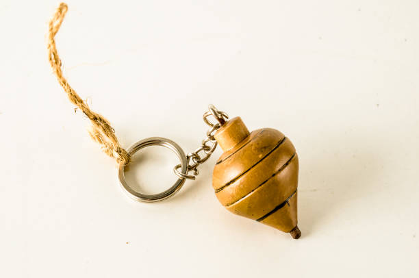 istock A wooden key chain with a key hanging from it 2195383761