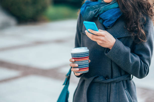 istock Young woman texting outdoors 2195389065