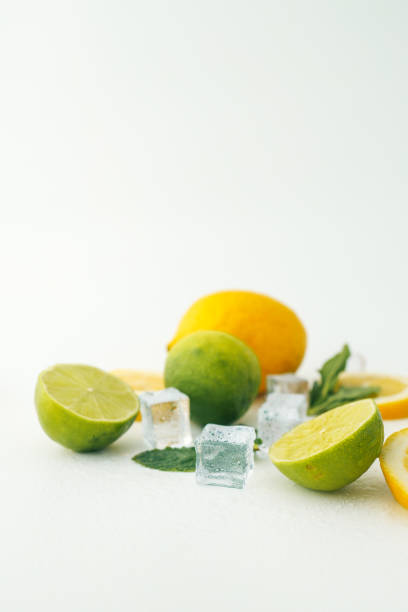 istock Fresh lime and lemon halves with mint leaves and ice cubes on a white background. A vibrant composition showcasing citrus fruits, perfect for healthy food, drinks, or summer themes 2195391268