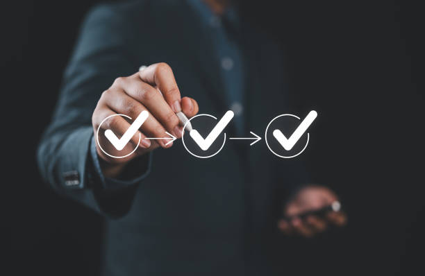 istock Businessman writing to tick correct mark in checklist with progressive loading status to remind work task progressive for project develop management and tracking concept. 2195391340