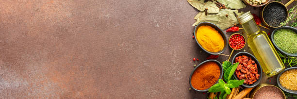 istock A visually striking arrangement of fresh spices and herbs on a brown surface, highlighting their vivid colors, intricate details, and rich culinary essence, banner 2195391560