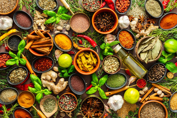 istock A diverse collection of vibrant spices and herbs, elegantly positioned on a brown backdrop, exuding natural beauty and a burst of fragrances 2195391562