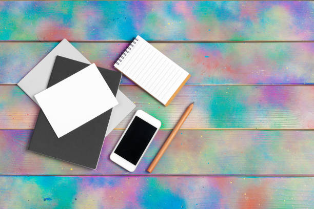 smartphone, tablet, notebook pen on the background of a wooden table